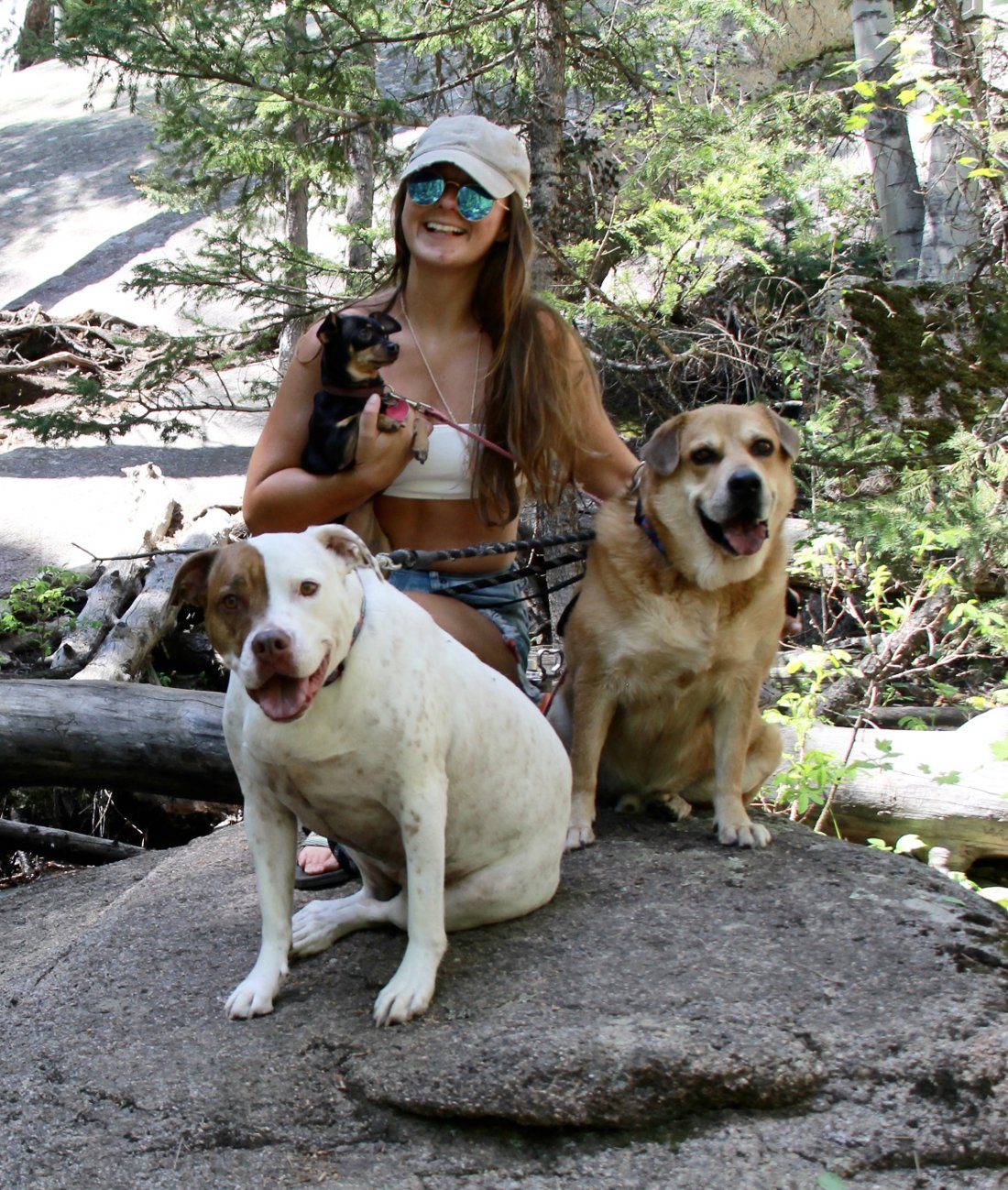 Kelsey hiking with three dogs